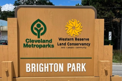 Sign for Brighton Park featuring logos of Cleveland Metroparks and Western Reserve Land Conservancy.