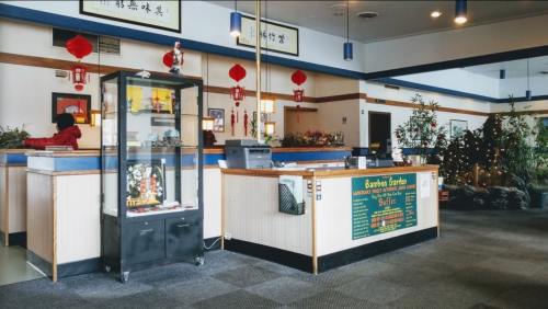Interior of a restaurant featuring a reception area, decorative displays, and festive decorations.