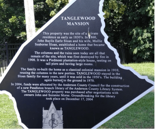 Sign about Tanglewood Mansion's history, including its construction, restoration, and connection to the local library.