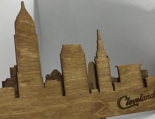 Wooden silhouette of Cleveland's skyline featuring iconic buildings, with "Cleveland" engraved at the bottom.