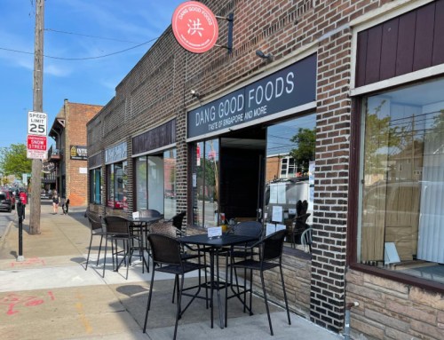 Exterior of "Dang Good Foods" restaurant with outdoor seating, brick facade, and a clear blue sky.