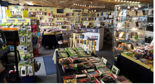 A retail store filled with various phone accessories, cases, and displays, featuring bright lighting and organized shelves.