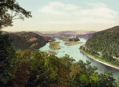 A scenic view of a winding river surrounded by lush hills and trees, with a soft pastel sky above.