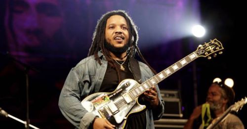 Closeup of Stephen Marley, a musician and son of Bob Marley, signing at a concert