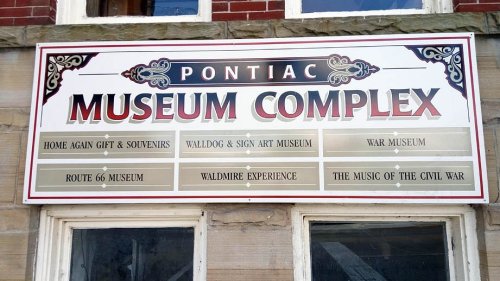 Sign for Pontiac Museum Complex listing various attractions, including War Museum and Route 66 Museum.