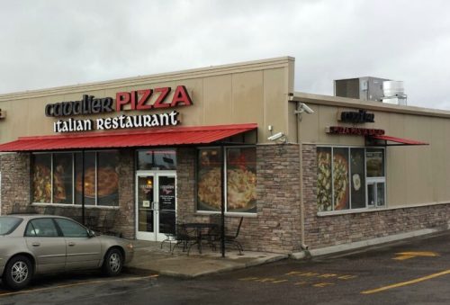 Exterior of Cavalier Pizza Italian Restaurant, featuring a stone facade and red awning, with a parked car in front.