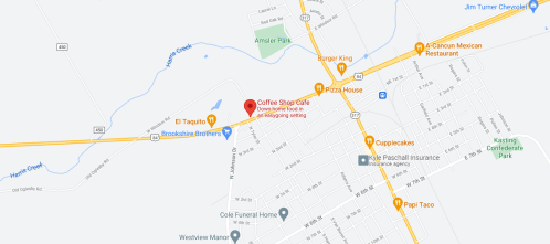 Map showing a Coffee Shop Cafe location near various restaurants and parks, with nearby roads and landmarks labeled.