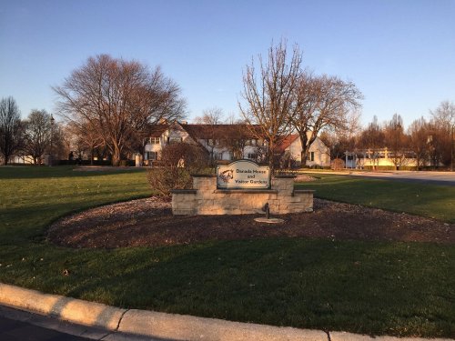 Sign for "Danada House" in Winter Garden, surrounded by landscaped grass and trees under a clear sky.