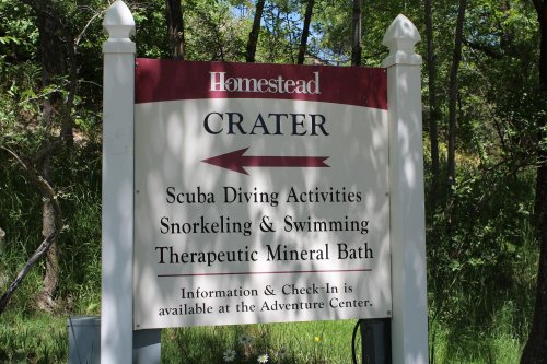 Sign for Homestead Crater, listing activities like scuba diving, snorkeling, swimming, and therapeutic mineral baths.