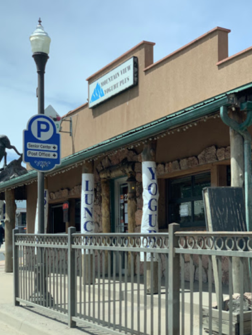 A storefront with a sign reading "Mountain View Yogurt Plus," featuring banners for lunch and yogurt.
