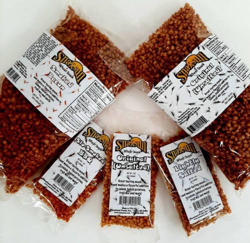 Five bags of Snack Sun popcorn kernels in various flavors, including original and lightly salted, displayed on a white background.
