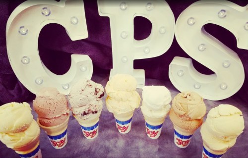 Colorful ice cream cones in front of large, illuminated letters spelling "CPS."