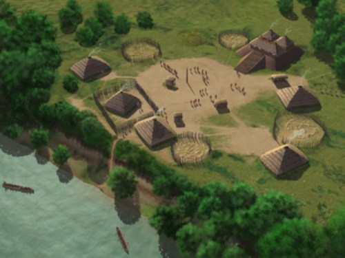 Aerial view of a historical village with huts, a central area, and people near a river surrounded by trees.