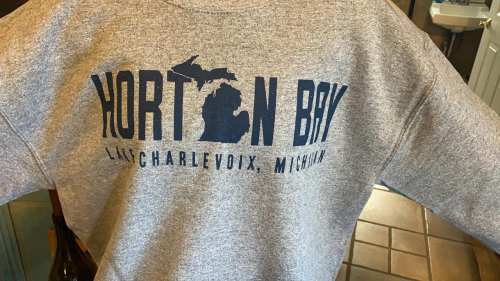 Gray sweatshirt featuring "Norton Bay" and "Charlevoix, Michigan" with a Michigan outline graphic.