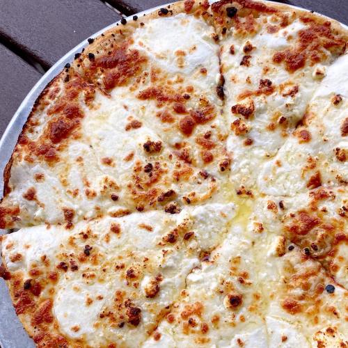 A freshly baked cheese pizza with golden, bubbly cheese and a crispy crust, served on a silver tray.