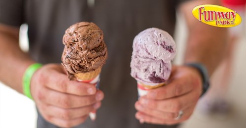 A person holds two ice cream cones, one chocolate and one purple, in front of a Funway Park logo.