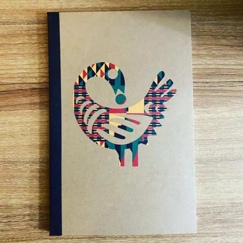 A colorful, patterned bird illustration on a brown notebook cover with a black spine.