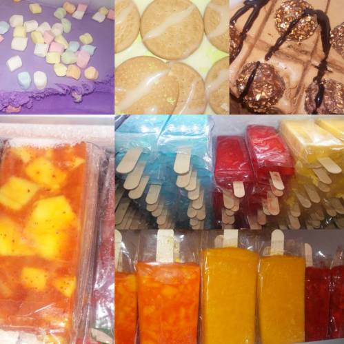 A colorful assortment of sweets: marshmallows, cookies, chocolate treats, and various popsicles in vibrant colors.