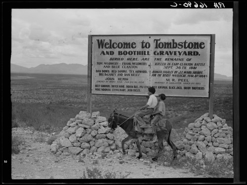 A historical sign welcomes visitors to Tombstone and Boothill Graveyard, listing notable buried individuals.