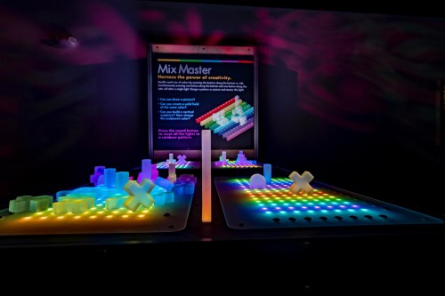 Interactive display titled "Mix Master" featuring colorful, illuminated blocks and shapes on a dark background.