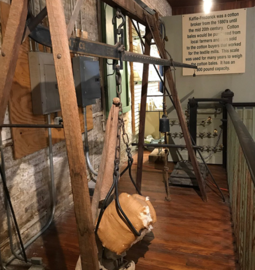 A vintage cotton scale from the 1880s, used to weigh cotton bales in a historical setting.