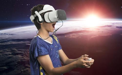 A child wearing a VR headset, excitedly playing a game against a cosmic background with a glowing sun.