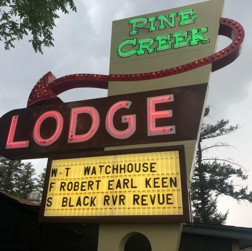 Sign for Pine Creek Lodge featuring upcoming events: Watchhouse, Robert Earl Keen, and Black River Revue.