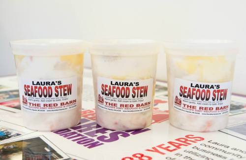 Three containers of "Laura's Seafood Stew" from The Red Barn, labeled with bold text on a white background.