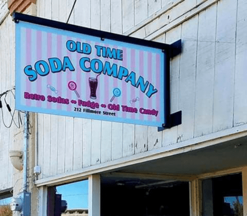 Sign for "Old Time Soda Company" featuring retro sodas, fudge, and candy, located at 212 Fillmore Street.