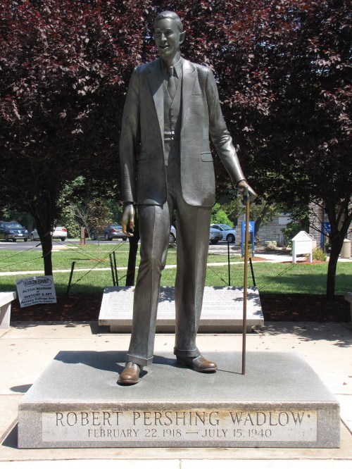 Statue of Robert Wadlow, the tallest man in history, with an inscription detailing his birth and death dates.