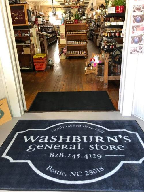 Entrance to Washburn's General Store, featuring a welcome mat and shelves stocked with various goods.