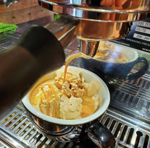 A close-up of espresso pouring over a bowl of ice cream, creating a delicious coffee dessert.