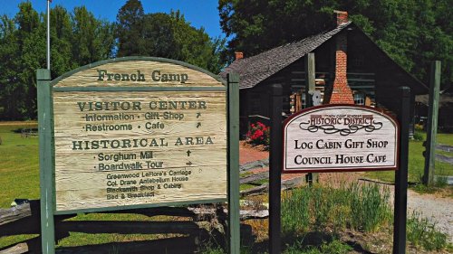 Signage for French Camp, featuring visitor center info, historical area details, and nearby gift shop and café.