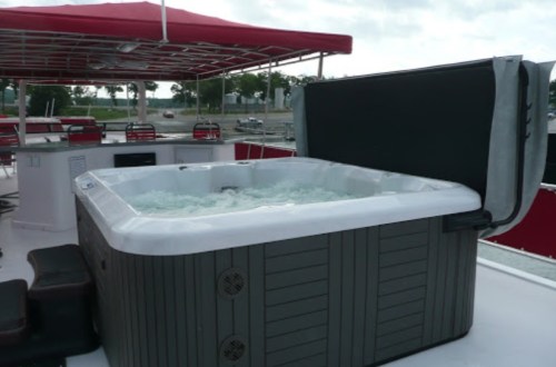 A hot tub on a boat deck, with water bubbling and a canopy overhead.