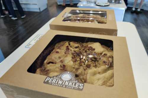 Two boxed pies with a nut topping, displayed on a table at Periwinkle's Bakery & Cafe.