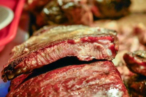 Close-up of juicy, grilled meat with a smoky char, showcasing tender texture and rich color.