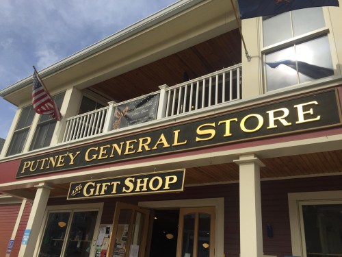 Exterior of Putney General Store and Gift Shop, featuring a large sign and American flag.