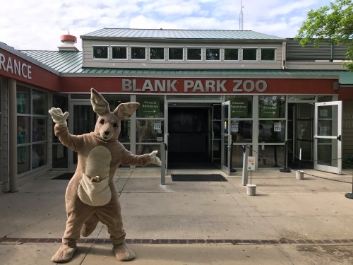 A kangaroo mascot stands in front of the entrance to Blank Park Zoo, welcoming visitors.