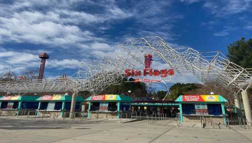 Entrance to Six Flags amusement park with a geometric archway and blue sky in the background.