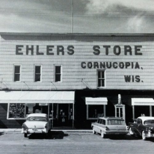 Black and white photo of Ehlers Store in Cornucopia, Wisconsin, with vintage cars parked outside.