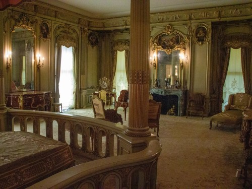 Luxurious vintage bedroom with ornate decor, mirrors, and elegant furniture, featuring soft lighting and rich textures.
