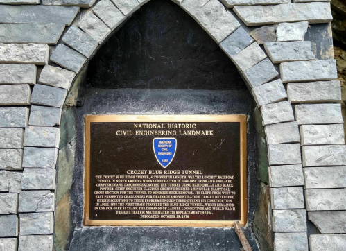 Plaque marking the Crozet Blue Ridge Tunnel, a National Historic Civil Engineering Landmark, with stone arch background.