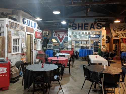 A vintage-themed diner with tables, retro signs, and decor, featuring a cozy, nostalgic atmosphere.