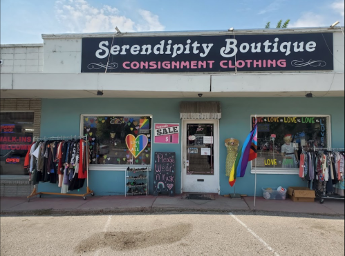 Exterior of Serendipity Boutique, featuring a colorful sign, clothing racks, and a welcoming storefront.