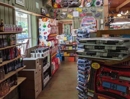 A colorful store aisle filled with shelves of drinks, snacks, and vintage items, creating a nostalgic atmosphere.