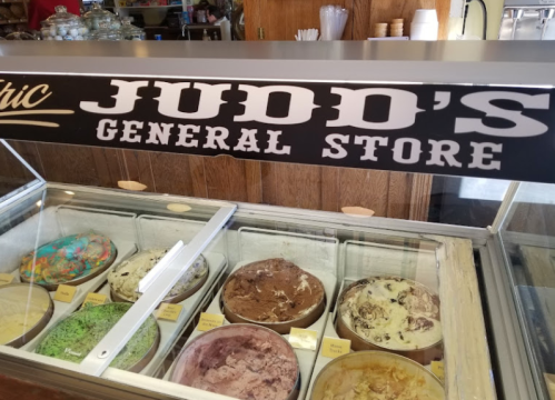 A display of various ice cream flavors at Judd's General Store, with a sign overhead.