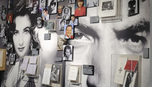 A collage of black-and-white photos of celebrities, with memorabilia displayed on a wall featuring prominent faces.