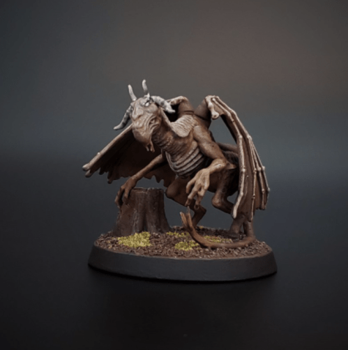 A detailed miniature of a creature with bat-like wings, claws, and a skeletal appearance, posed on a textured base.
