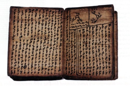 An open ancient book with handwritten text and illustrations on aged pages.