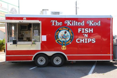 A red food truck named "The Kilted Kod" serving fish and chips, with a menu displayed in the window.